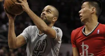 San Antonio Spurs guard Tony Parker, left, of France, shoots sd Houston Rockets guard Jeremy Lin watches during the first half of an NBA basketball game on Wednesday, Dec. 25, 2013, in San Antonio. (AP Photo/Darren Abate)
