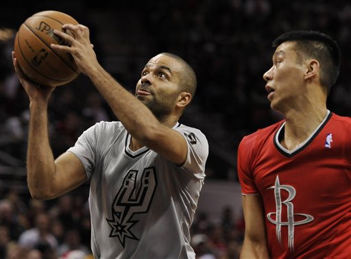 San Antonio Spurs guard Tony Parker, left, of France, shoots sd Houston Rockets guard Jeremy Lin watches during the first half of an NBA basketball game on Wednesday, Dec. 25, 2013, in San Antonio. (AP Photo/Darren Abate)