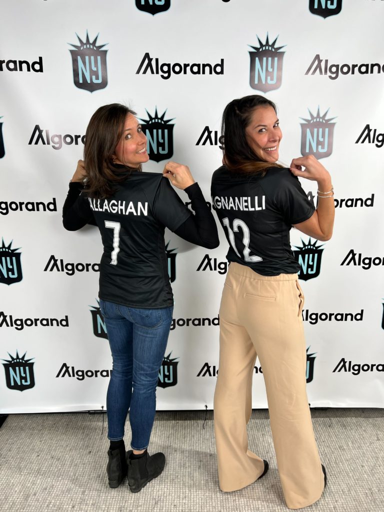 Kelli Callaghan of Algorand and Andrea Pagnanelli of Gotham FC pose together in Gotham FC jerseys.