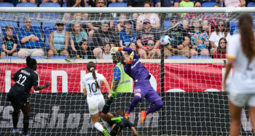 Goalkeeper Ashlyn Harris attampts a jumping save on Shae Groom shot that hits the back of the net