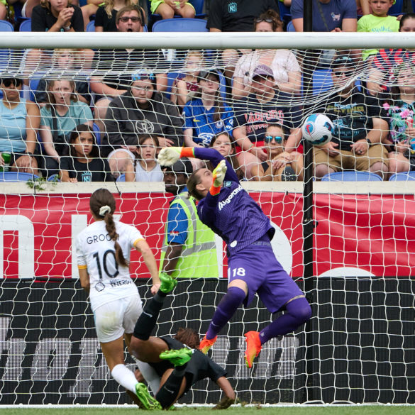 Goalkeeper Ashlyn Harris attampts a jumping save on Shae Groom shot that hits the back of the net