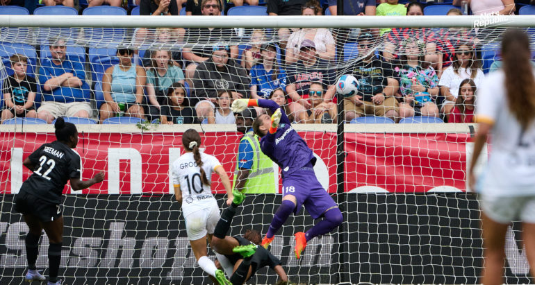 Goalkeeper Ashlyn Harris attampts a jumping save on Shae Groom shot that hits the back of the net