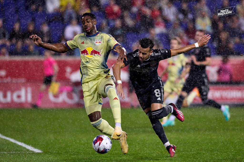 Red Bulls defender Andres Reyes shields the ball away from Dynamo winger Amine Bassi in New York's 1-1 draw to Houston on Saturday, April 15th.